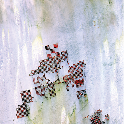 "Geometric shapes lie across the emptiness of the Sahara Desert in southern Egypt. Each point is a center pivot irrigation field a little less than 1 kilometer (0.6 miles) across. With no surface water in this region, wells pump underground water to rotating sprinklers from the huge Nubian Sandstone aquifer, which lies underneath the desert." - USGS